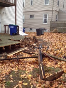 The rear deck of 20 Lovell Street showing damage resulting from a fire spreading from an adjacent yard. ~Photo by Somerville Fire Department