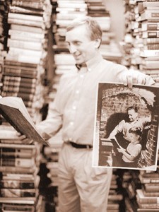 Kenneth Gloss holds a picture of himself as a child with his father,  working together in the book store.