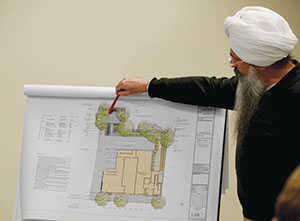 Architect Jai Singh Khalsa presented details of the proposed building to attendees at Thursday’s neighborhood meeting. ~Photo by Claudia Ferro