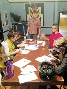 Members of Fossil Free Somerville write letters to elected officials asking them to support S.1225, a bill that would require the Massachusetts Pension Reserves Investment Trust to freeze new investments in fossil-fuel companies and urge a transition of new investments to renewable energy-related organizations. Fossil Free Somerville spearheaded the effort to have the Board of Aldermen hold a public hearing to discuss having the Retirement Board divest from any investments tied to the fossil-fuel industry. ~ Photo courtesy Fossil Free Somerville/Facebook 