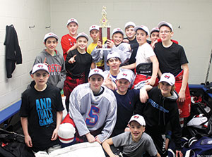 The 2014 Somerville Youth Hockey Middle School Team, post game, celebrating their Valley League Championship win in the locker room. Front row lying down, Ryan Vogel. 2nd row kneeling, left to right, Chris Desousa, C.J. Resmini, Nolan Roche, Gus Hawkins. 3rd row, left to right, Nathan Herra-Valente, Sean Sullivan, Anthony Parziale, Shayne Murphy, Jake Gunther. Back row, left to right, Jason Cassidy, Dylan Zraket, Derek Doane, Bobby Lavey and Brandon Lafee.