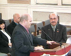 Ward 1 Alderman Matt McLaughlin expressed the city’s gratitude to Stiles (right) as he was presented with a citation honoring his 40 year career with the Somerville Police Department.