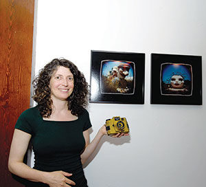 Michelle Bates shows off her toy camera works of art.