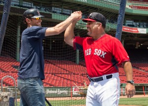 US Army Veteran and Somerville resident Nick Starling celebrates a great swing at the Green Monster with Boston Red Sox Assistant Hitting Coach Victor Rodriguez during a special CVS Caremark Baseball Camp held July 2 at the park.