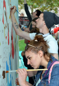 Megan Montgomery, of Boston  (In denim jacket Mural: Vinluan: Eric Vinluan of Jamaica Plain, MA  (in dark blue button down shirt) 