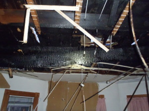  Heavy fire damage to the first floor ceiling at 893 Broadway where flames spread as occupants slept. ~Photo  courtesy of Somerville Fire Department.