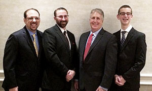 From left, Jeff Green, Master Brad Rogers, Master Mark Grupposo and Justin von Bosau celebrate Green's and von Bosau's successful completion of a black belt ranking test at the Westborough Doubletree Hotel last month.