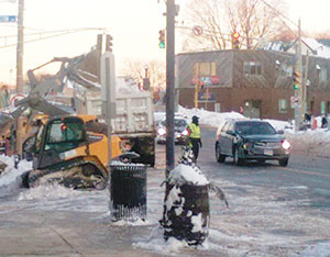 The cleanup effort continues as residents and city work crews labor to dig out from the second wave of snowfall that hit the area on Monday. ~ Photo by Bobby Potaris 