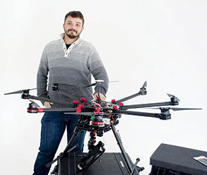 Jovan Tanasijevic shows off the drone that was used recently to help assess snow accumulation on rooftops throughout the city. ~Photo by Douglas Yu