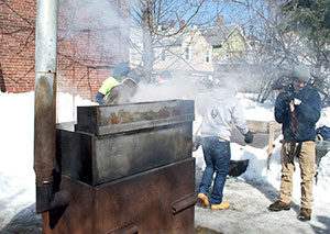 Volunteers come out to help boil down the sweet maple tree sap, while others come to sample the resulting syrup. ~Photos By Douglas Yu   