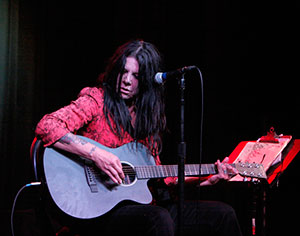 Johnette Napolitano, a solo gypsy with a kind of dangerous acoustic guitar. Photo by Barfly 