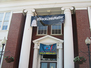 Black Lives Matter banner hangs above the entrance of City Hall in Somerville. — Photos by Bobbie Toner