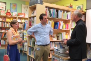 Daniel Griffin of Somerville talks with Father Michael Collins at Porter Square Books.