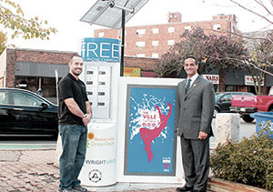 Mayor Curtatone shows off the city’s second Sustainaville/GreenTech pilot program solar powered charging station. ~ Photo courtesy of Sustainaville/GreenTech
