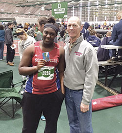 Gabrielle Etienne with her 2nd place medal in the Shot Put along with Coach Carl Stauffer.