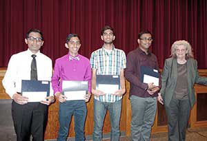 Erica Voolich congratulates Ashutosh Bhargo, Anmol Bhargo, Anmol Saini and Belal Sohel on winning Somerville Math Fund renewable scholarships for outstanding work in math and science. ~— Photo by Arthur Ingalls, Geskus Photography