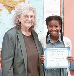 Erica Voolich congratulates Christina Bissereth on winning the Dr. Alice T Schafer Scholarship from the Somerville Math Fund for outstanding work in math and science.